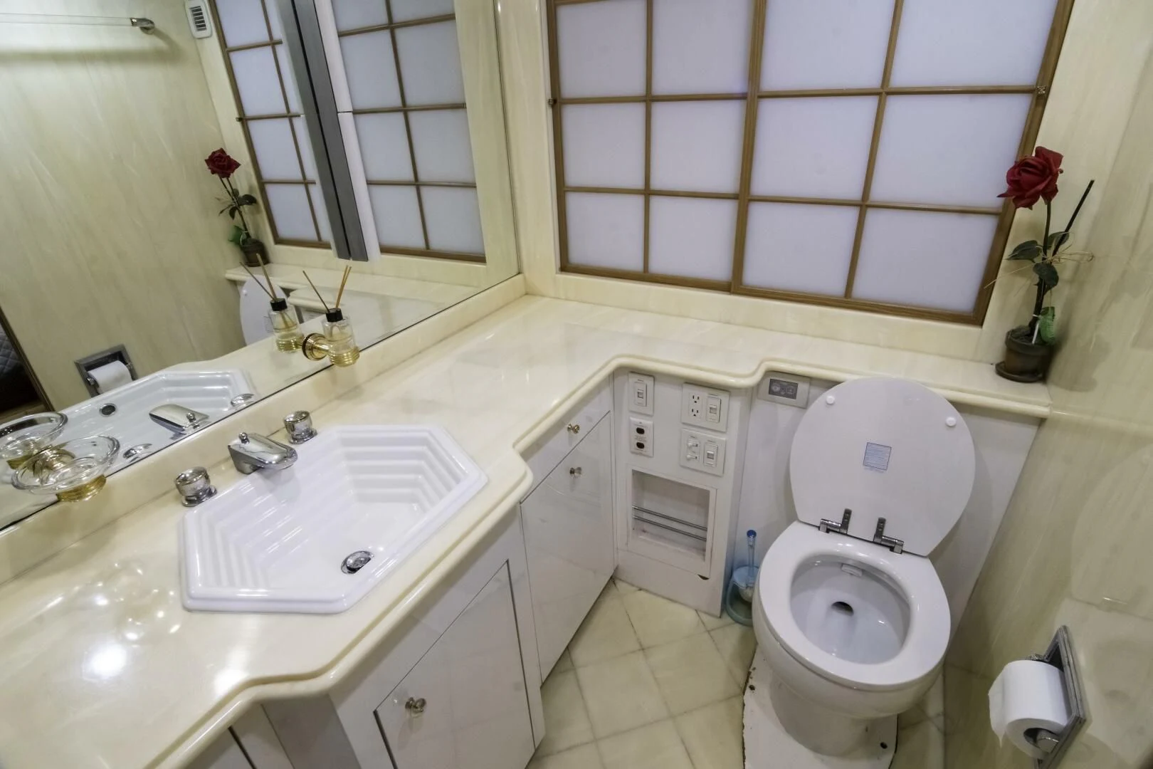 a bathroom with a toilet sink and a mirror aboard LADY AUDREY Yacht for Sale