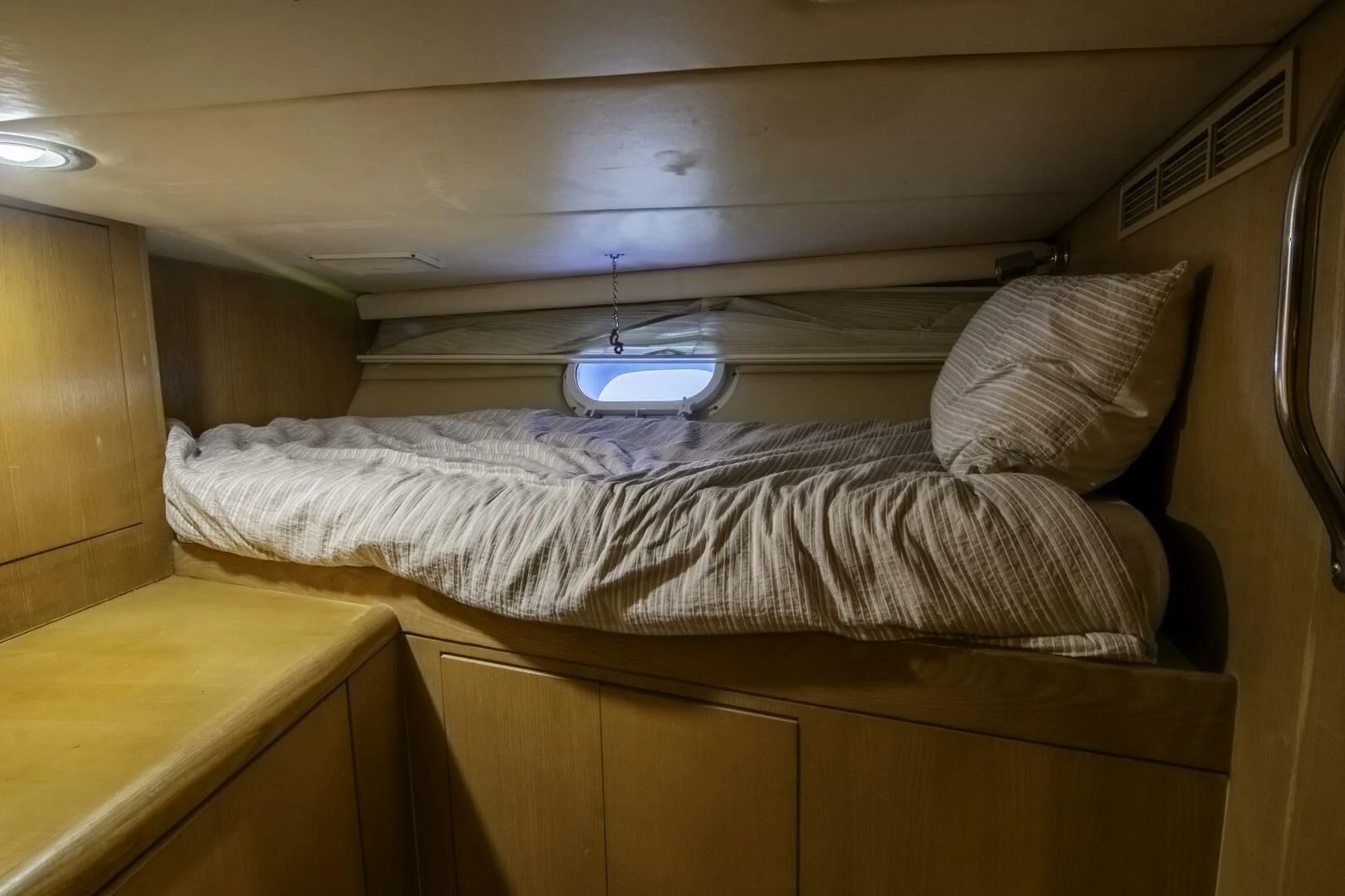 a bed with a white pillow aboard LADY AUDREY Yacht for Sale