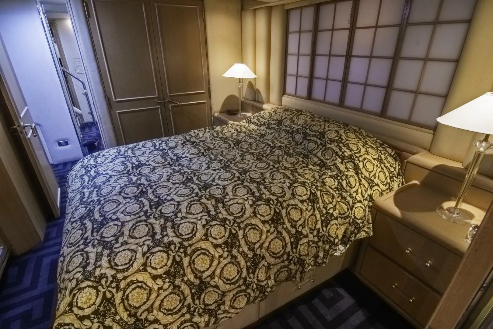 a bed with a white comforter aboard LADY AUDREY Yacht for Sale