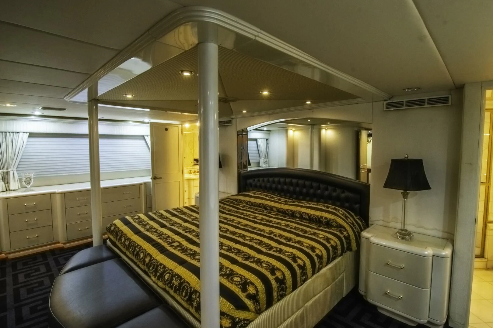 a large room with a bed and a lamp aboard LADY AUDREY Yacht for Sale