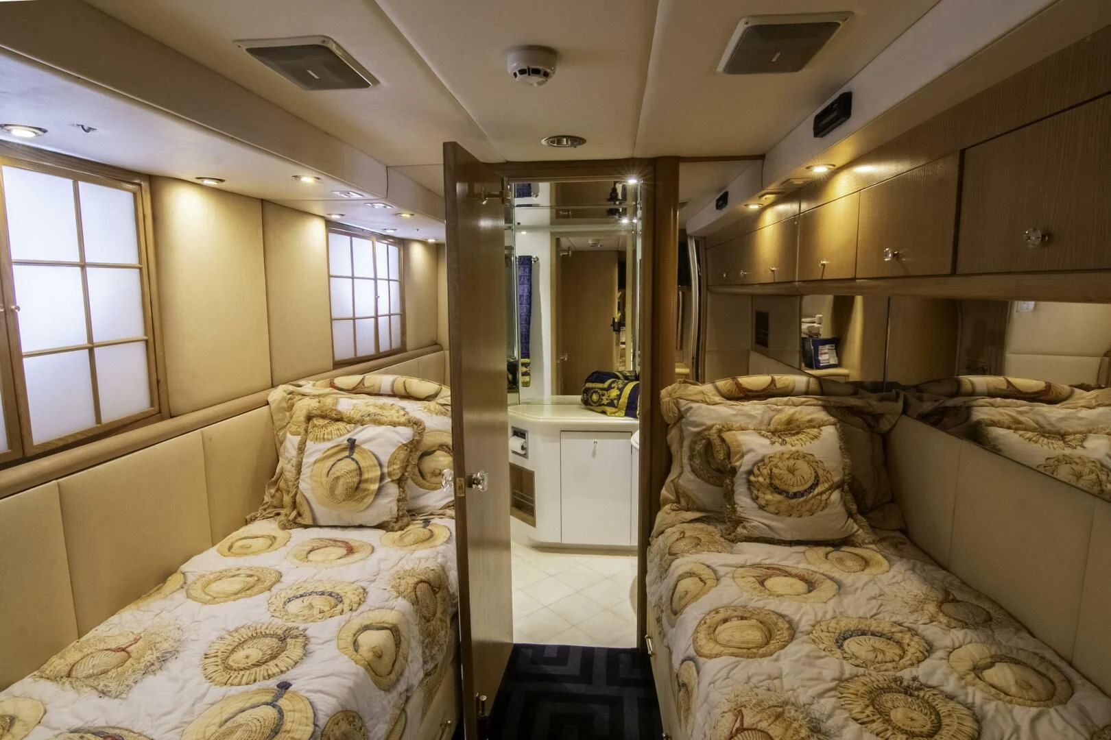 a room with beds and a mirror aboard LADY AUDREY Yacht for Sale