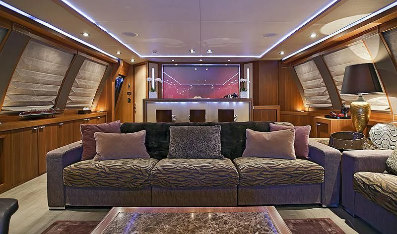 a living room with a couch and a tv aboard BAGHEERA Yacht for Charter