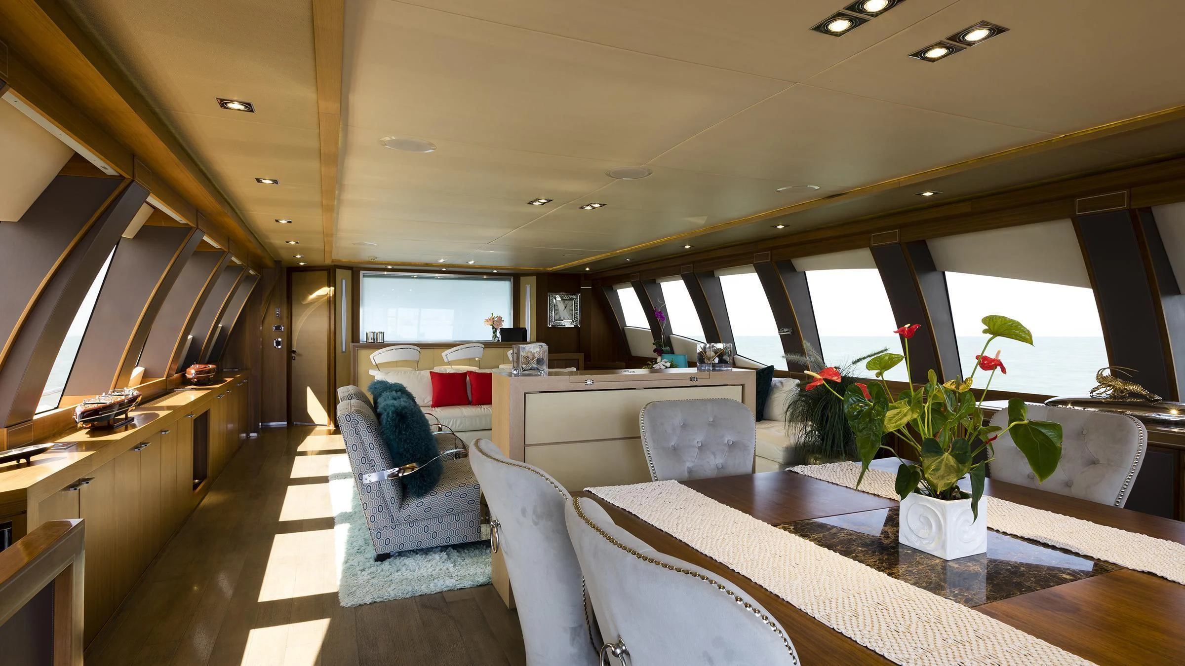 a room with a couch and a table and chairs aboard BAGHEERA Yacht for Charter