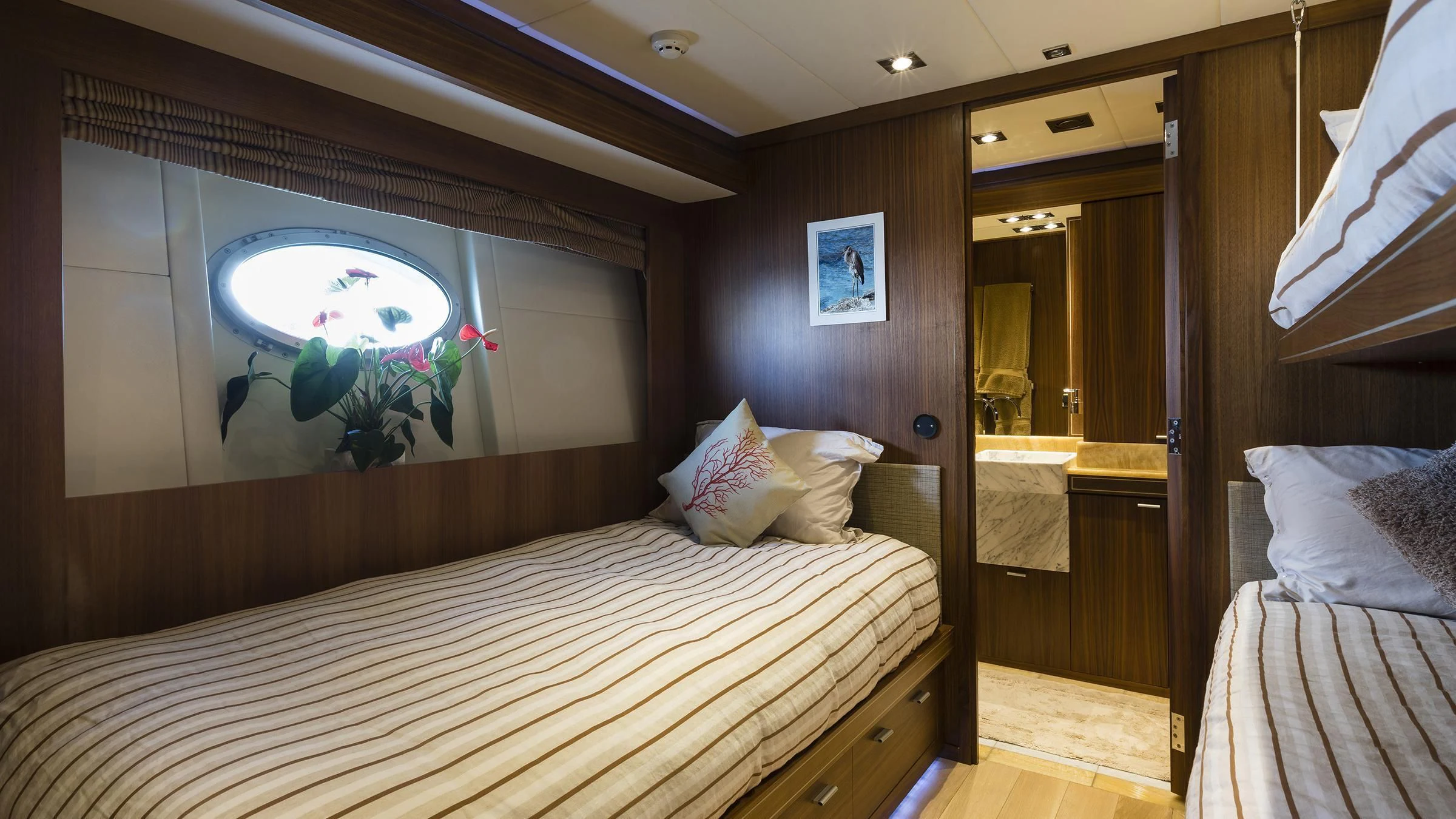 a room with a bed and a mirror aboard BAGHEERA Yacht for Charter