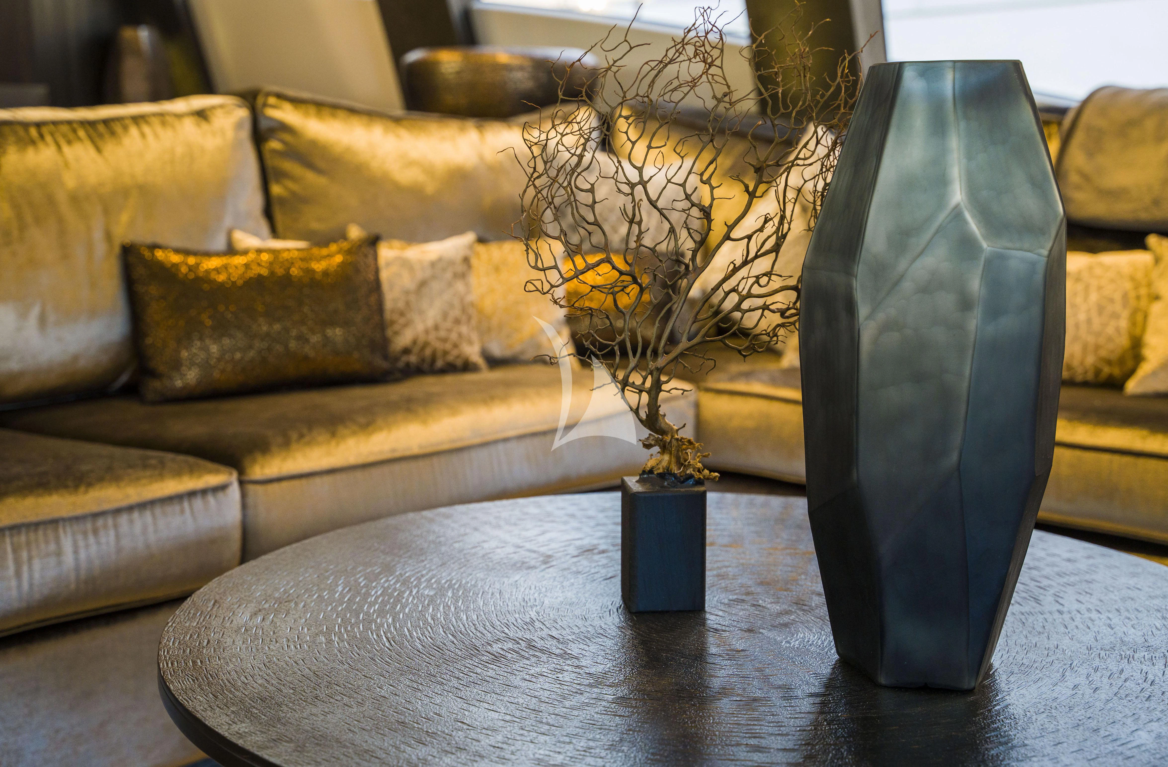 a glass vase sits on a coffee table aboard BAGHEERA Yacht for Charter