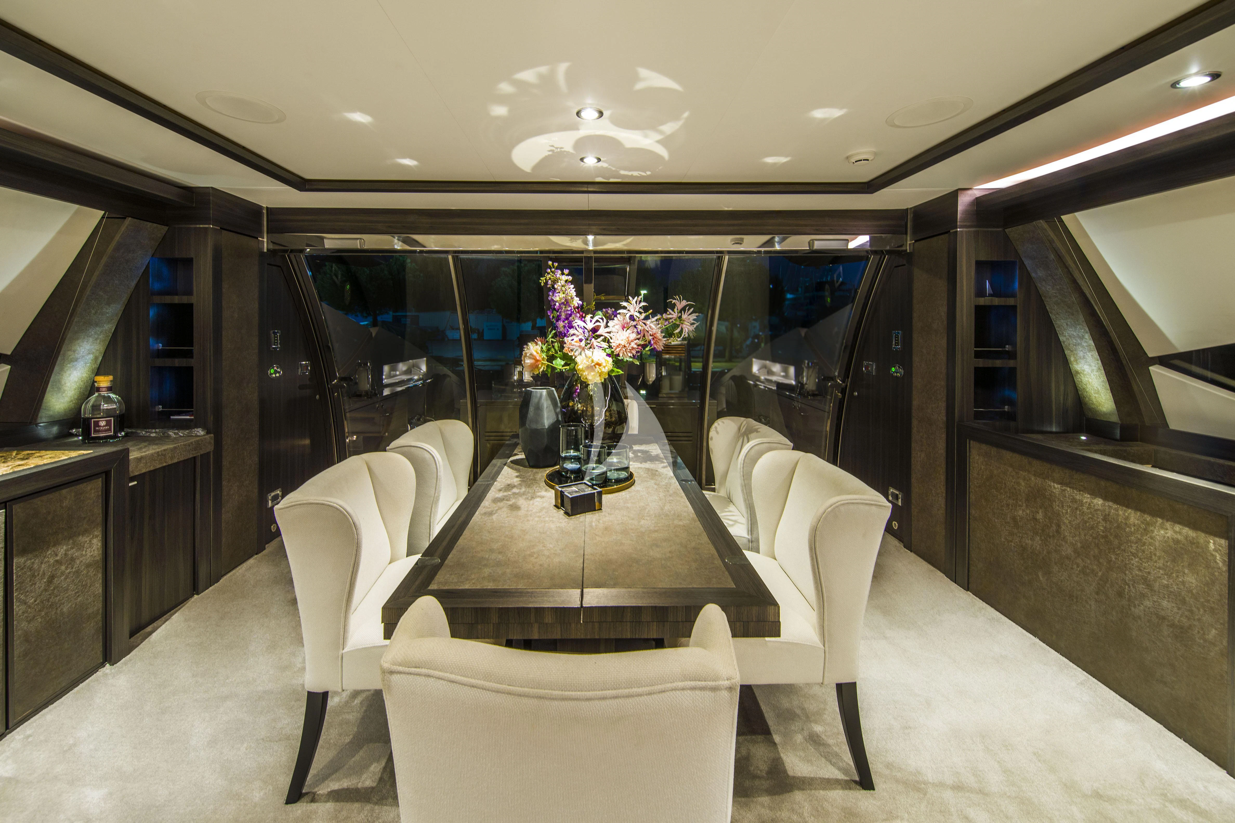 a room with a table chairs and flowers in it aboard BAGHEERA Yacht for Charter