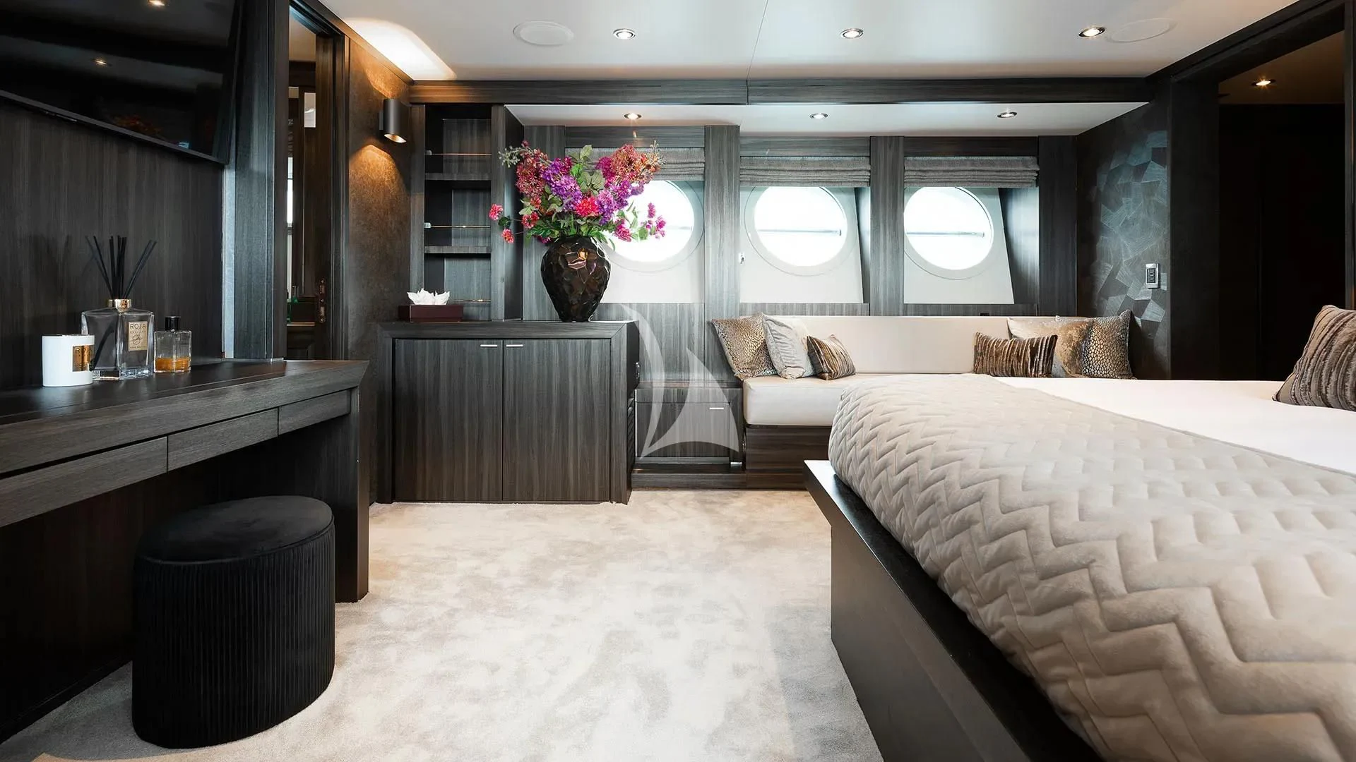 a room with a bed and a table aboard BAGHEERA Yacht for Charter