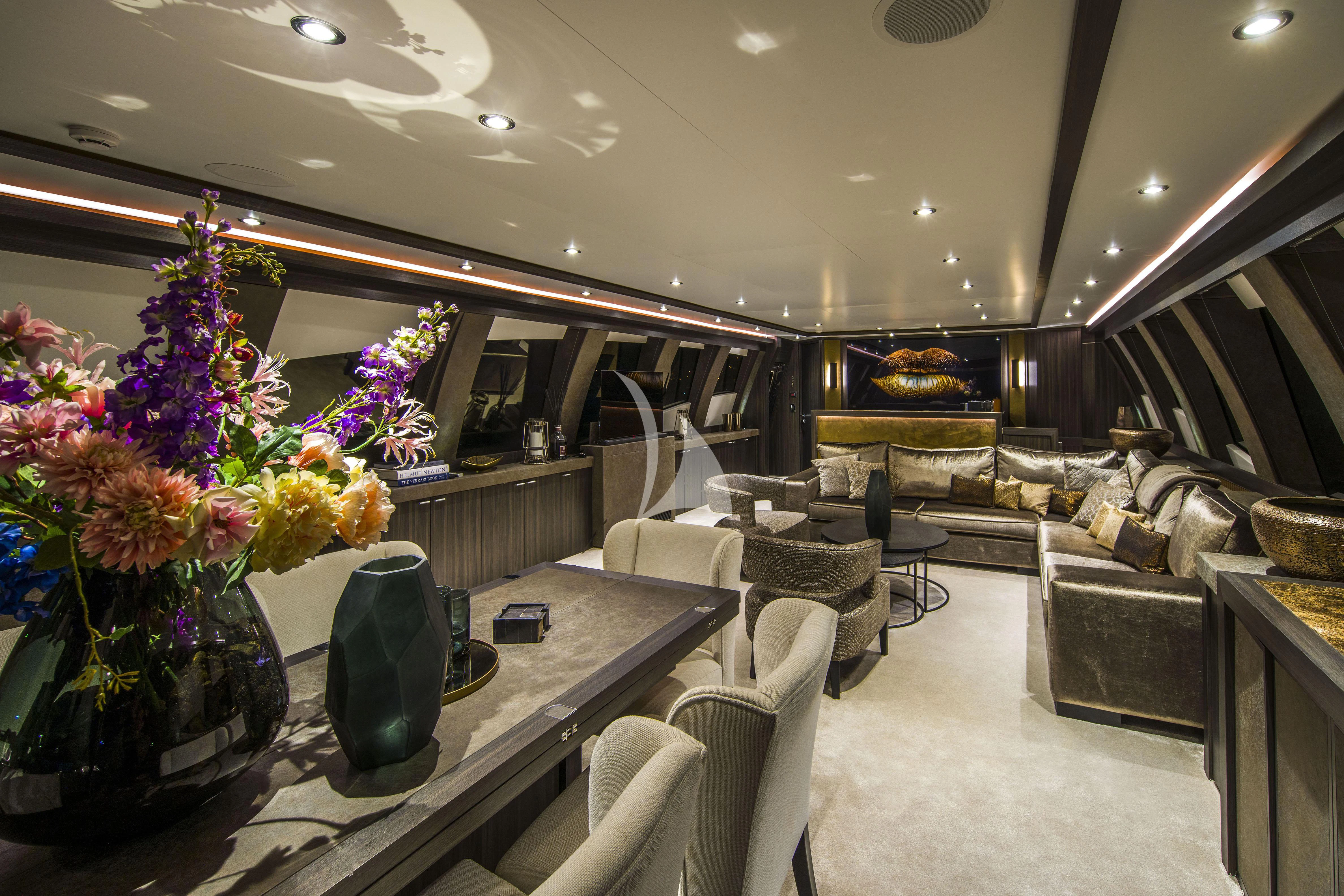 a living room with a large chandelier and a large mirror aboard BAGHEERA Yacht for Charter