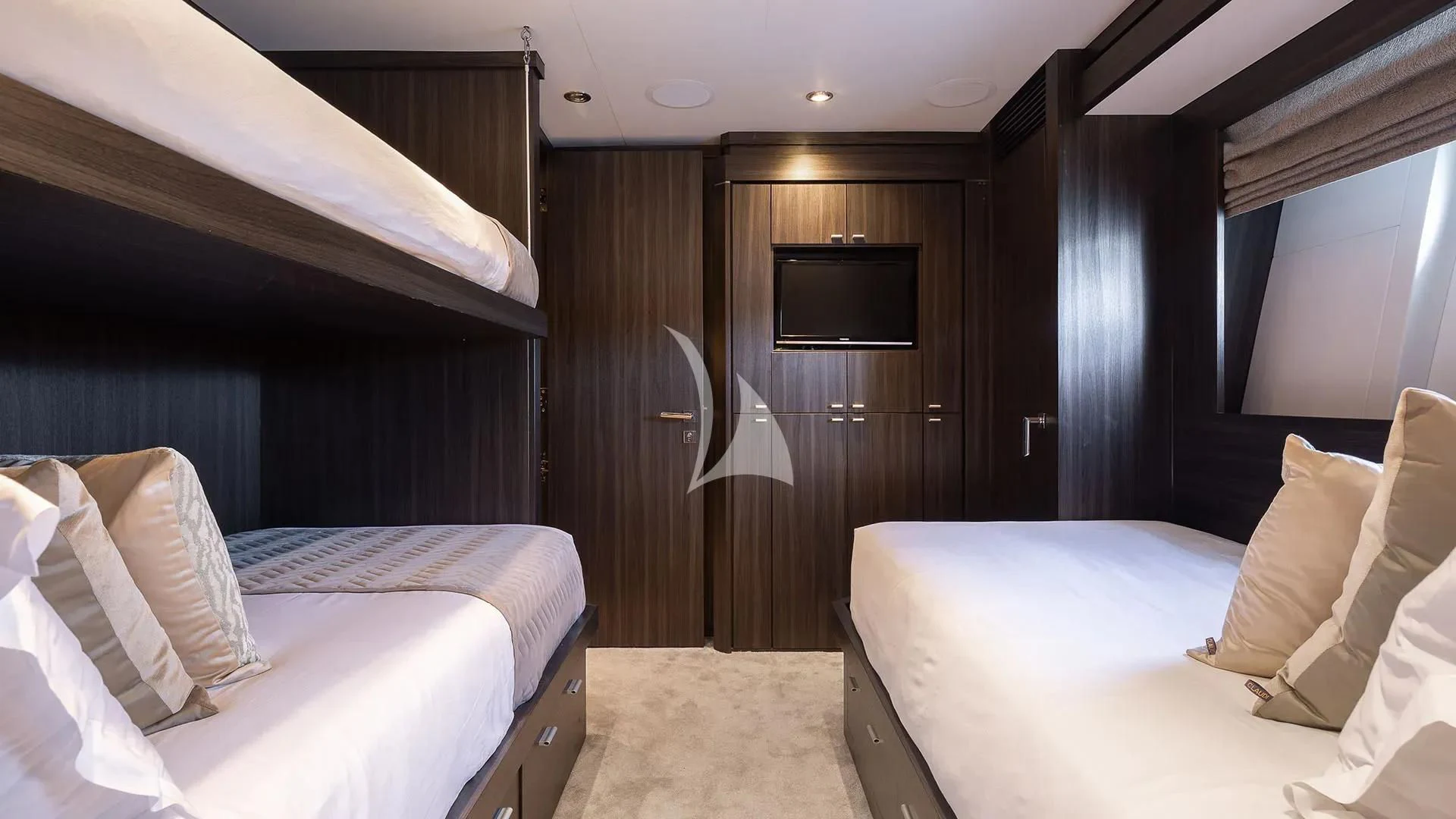 a room with a bed and a television aboard BAGHEERA Yacht for Charter