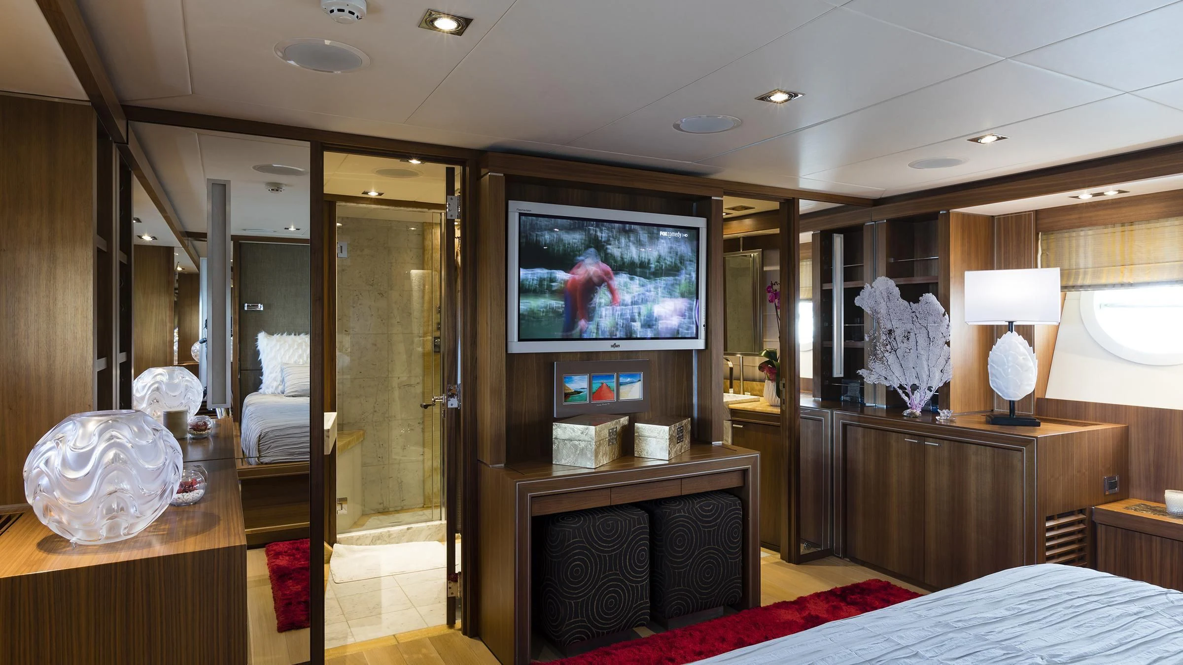 a room with a tv and a bed aboard BAGHEERA Yacht for Charter