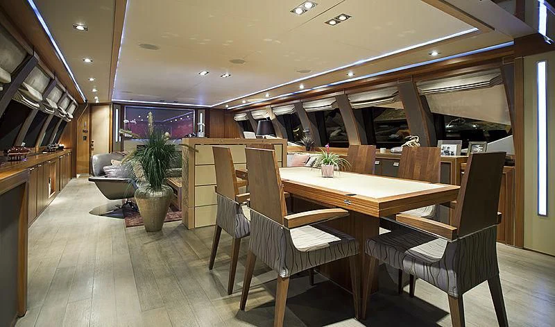 a room with a table chairs and a bench aboard BAGHEERA Yacht for Charter
