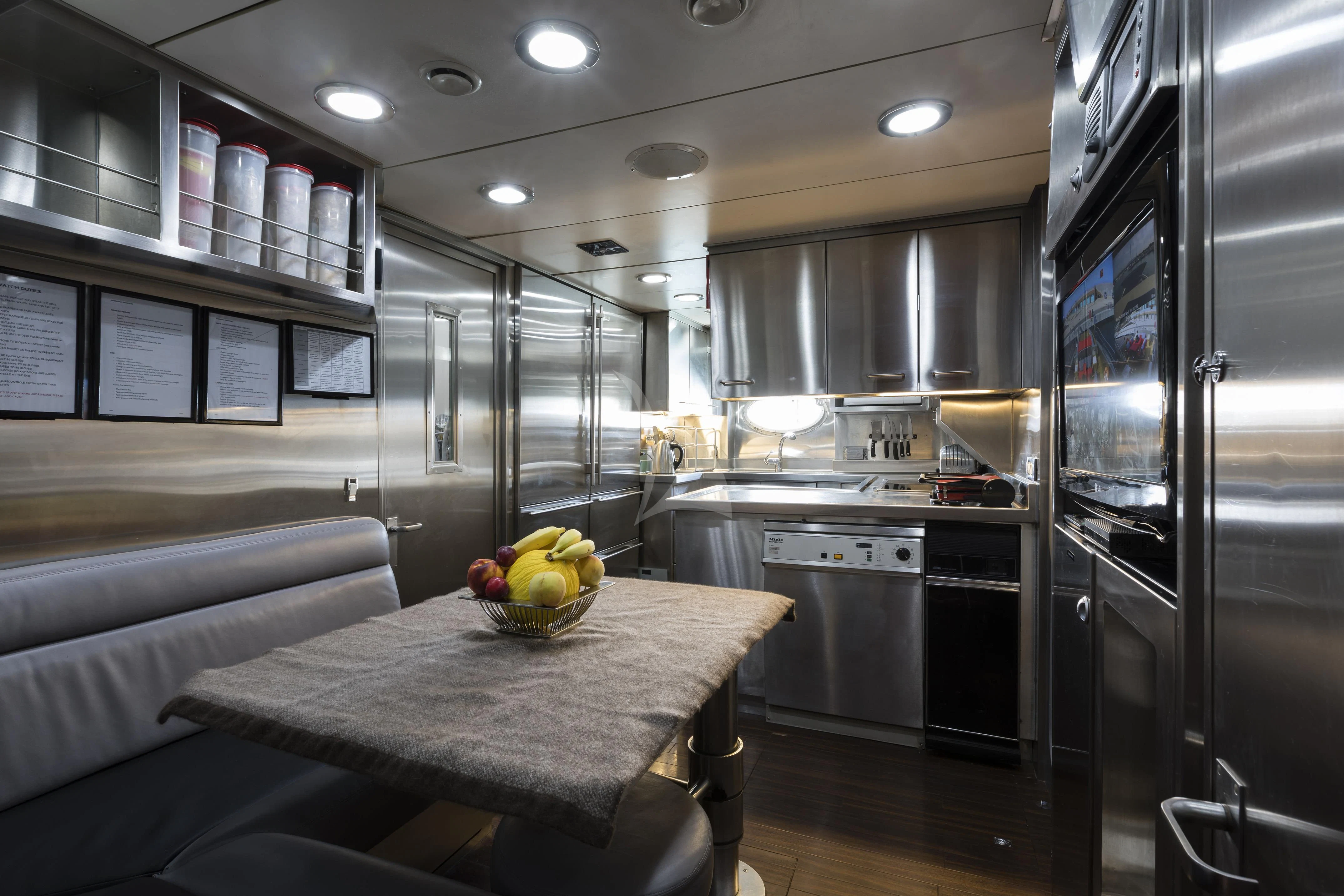 a kitchen with a table and a couch aboard BAGHEERA Yacht for Charter