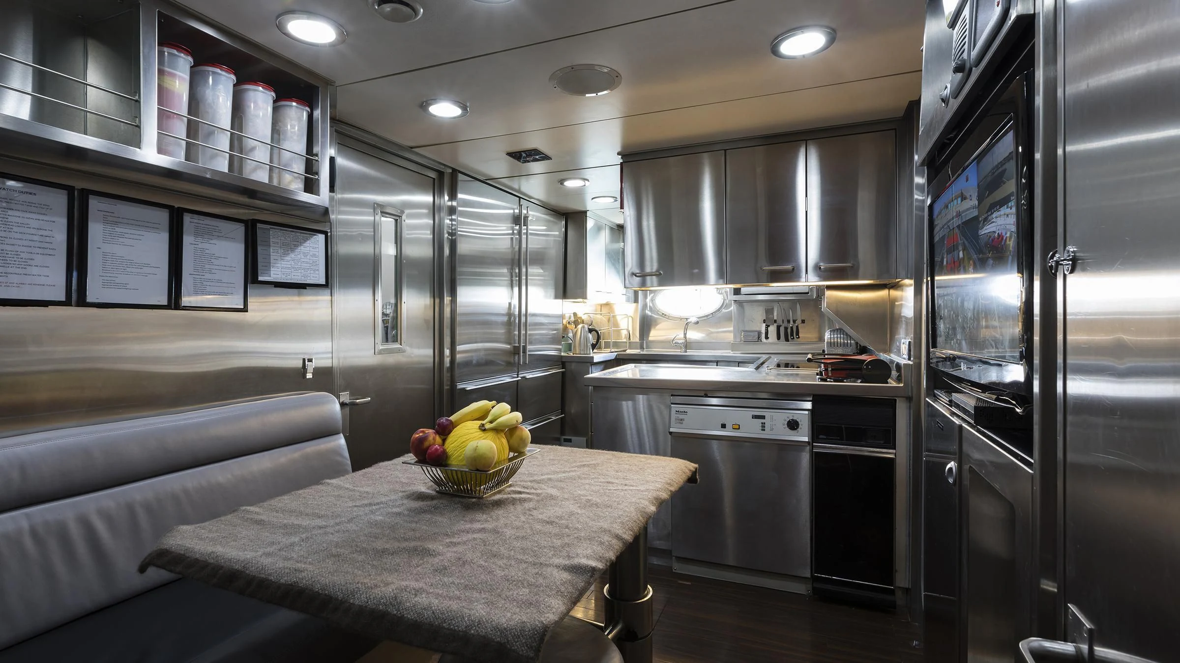 a kitchen with a table and a couch aboard BAGHEERA Yacht for Charter