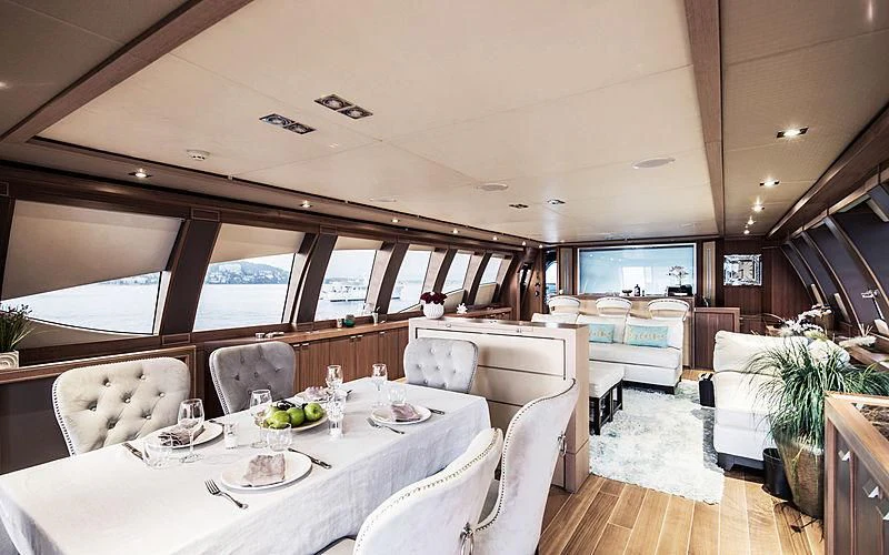 a dining room with a large window aboard BAGHEERA Yacht for Charter