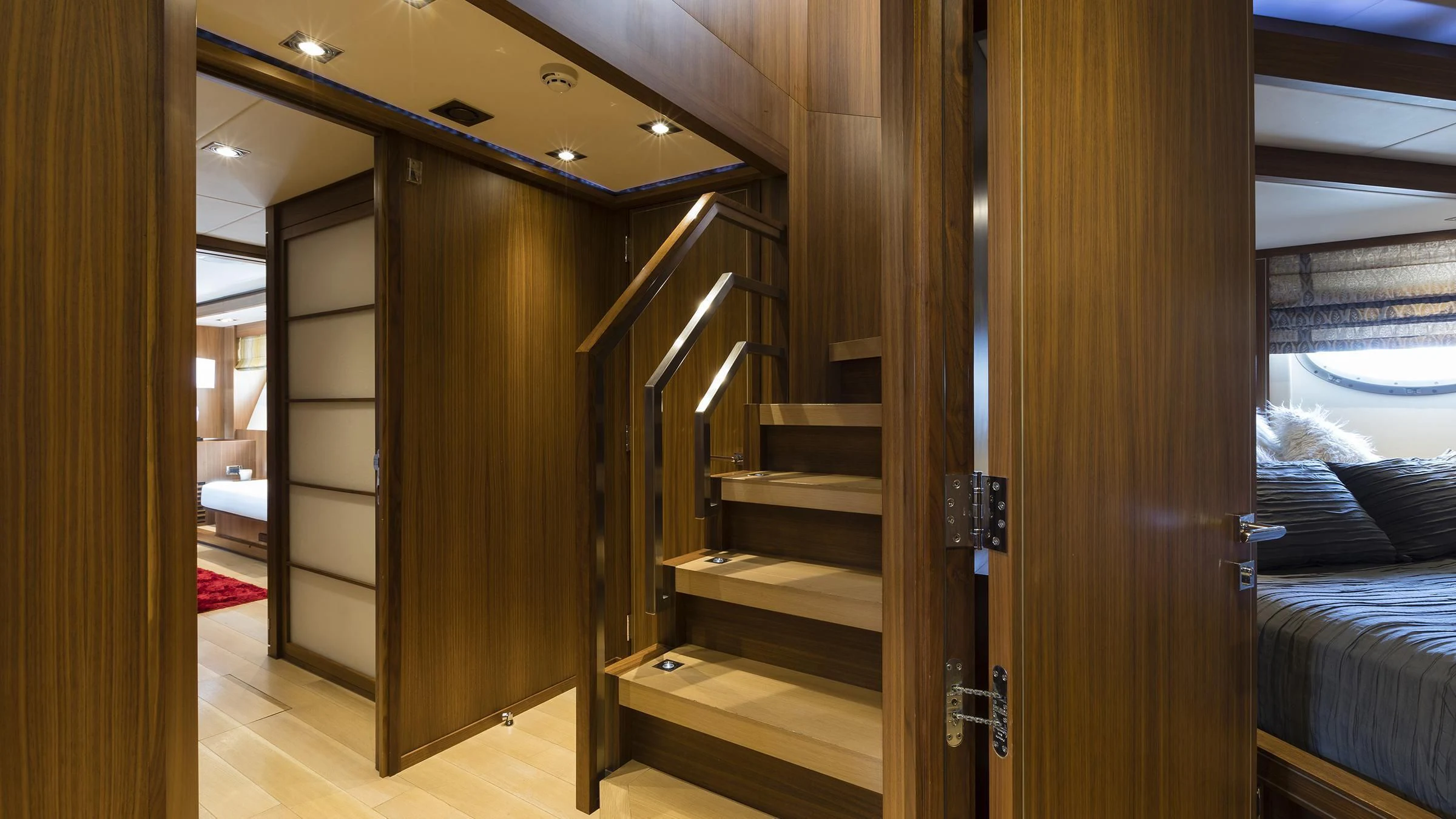 a room with a bunk bed and a wood door aboard BAGHEERA Yacht for Charter