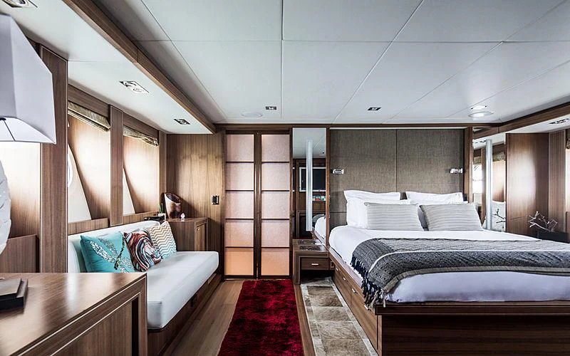 a room with a bed and a couch aboard BAGHEERA Yacht for Charter