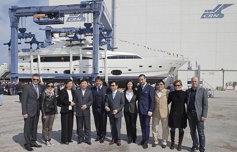 a group of people posing for a photo in front of a ship aboard SOUTH CHINA SEA WELKIN Yacht for Sale