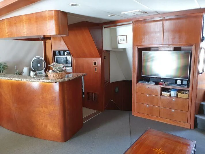 a kitchen with wooden cabinets aboard PHANTOM EXPLORER Yacht for Sale