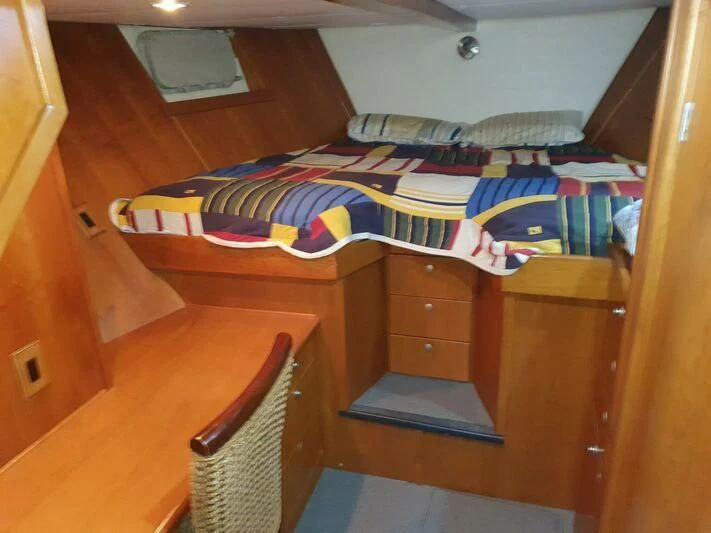a bed with a colorful comforter aboard PHANTOM EXPLORER Yacht for Sale