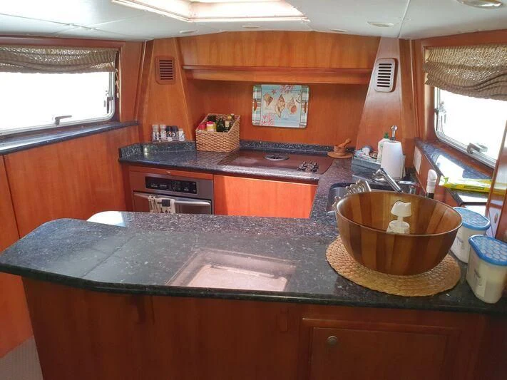 a kitchen with a large wooden counter aboard PHANTOM EXPLORER Yacht for Sale