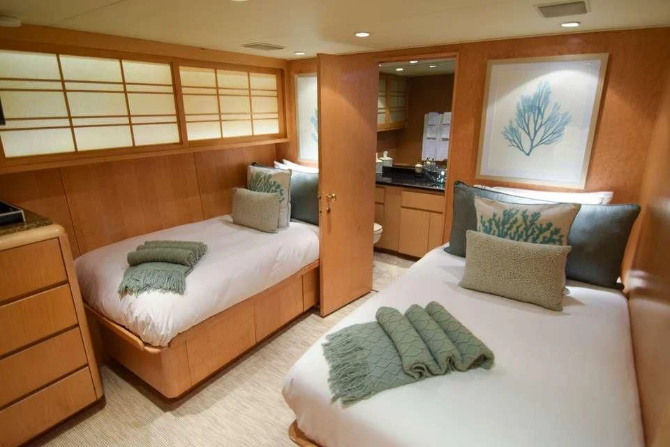 a couple of beds in a hotel room aboard ISLAND VIBE Yacht for Sale