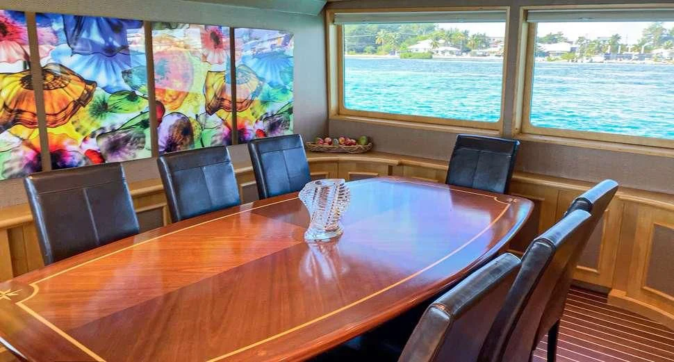 a table with chairs and a painting aboard ISLAND VIBE Yacht for Sale