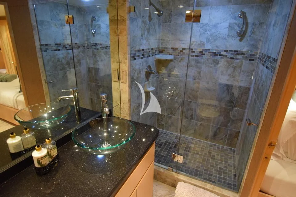 a bathroom with a glass shower aboard ISLAND VIBE Yacht for Sale