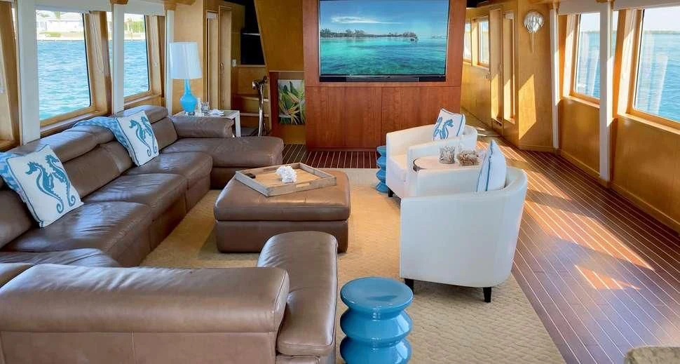 a living room with a large screen aboard ISLAND VIBE Yacht for Sale