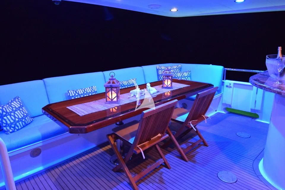 a table with chairs around it aboard ISLAND VIBE Yacht for Sale
