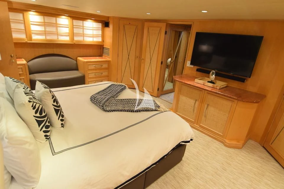 a bedroom with a bed and a tv aboard ISLAND VIBE Yacht for Sale