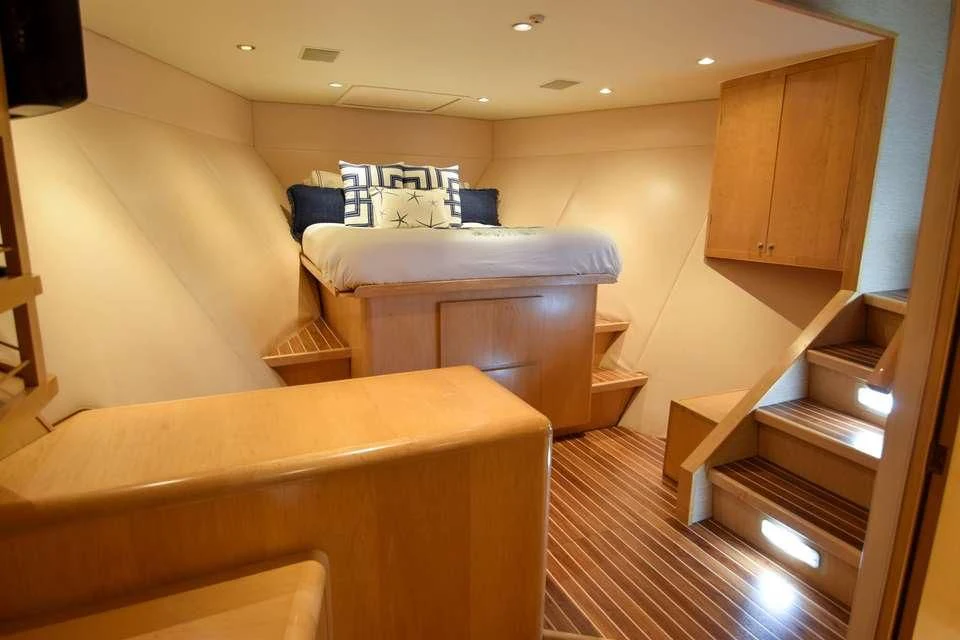 a room with a bed and a dresser aboard ISLAND VIBE Yacht for Sale