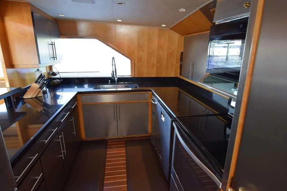 a kitchen with wooden cabinets aboard ISLAND VIBE Yacht for Sale