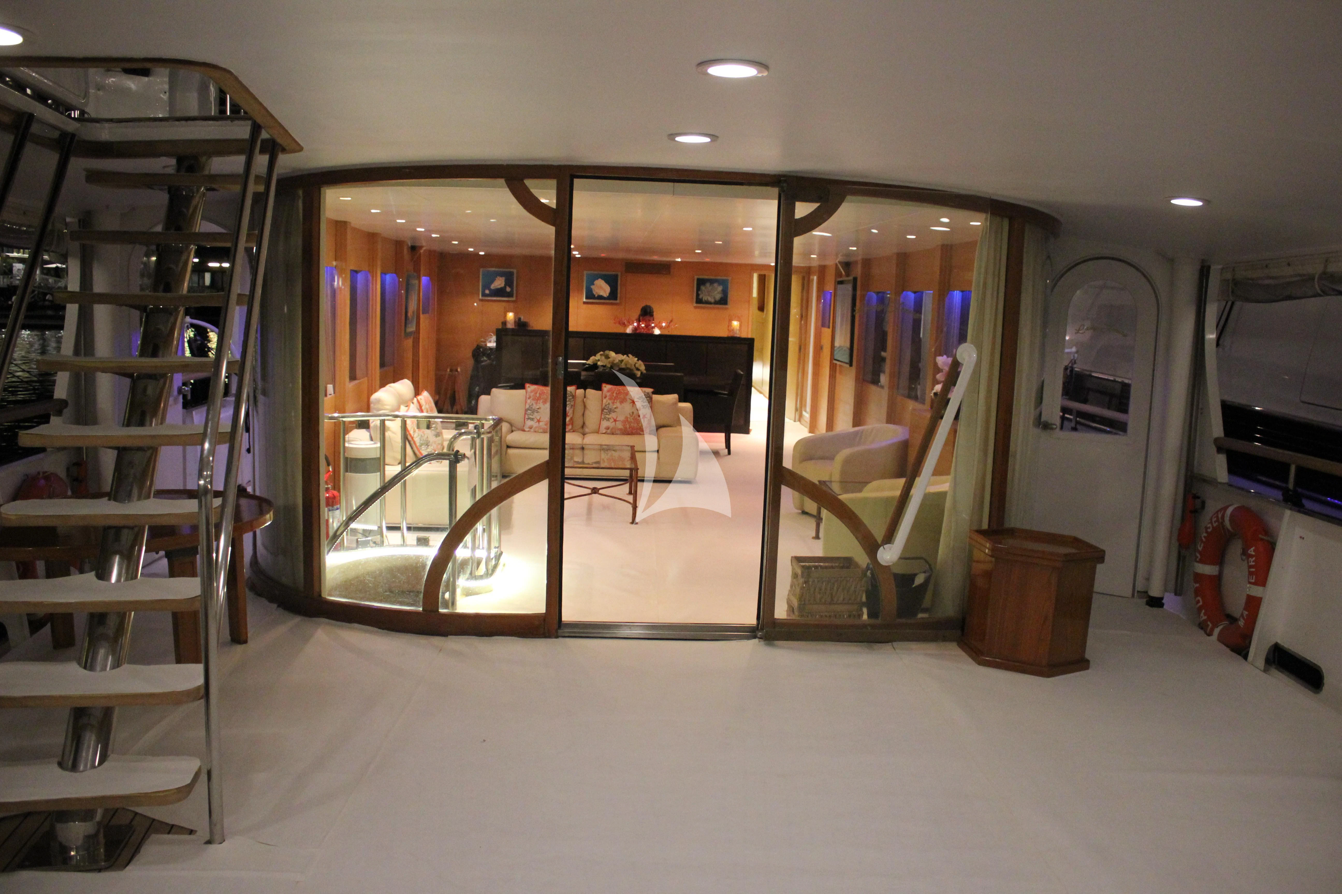 a room with a glass door and a mirror aboard LADY JERSEY Yacht for Charter