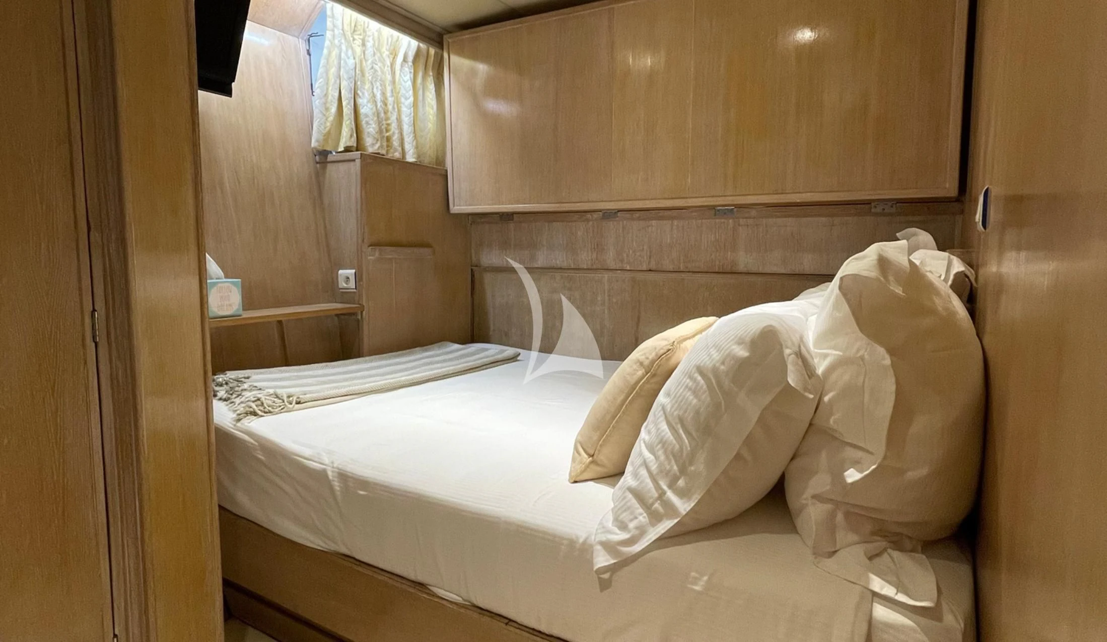 a bed with white sheets aboard LADY JERSEY Yacht for Charter