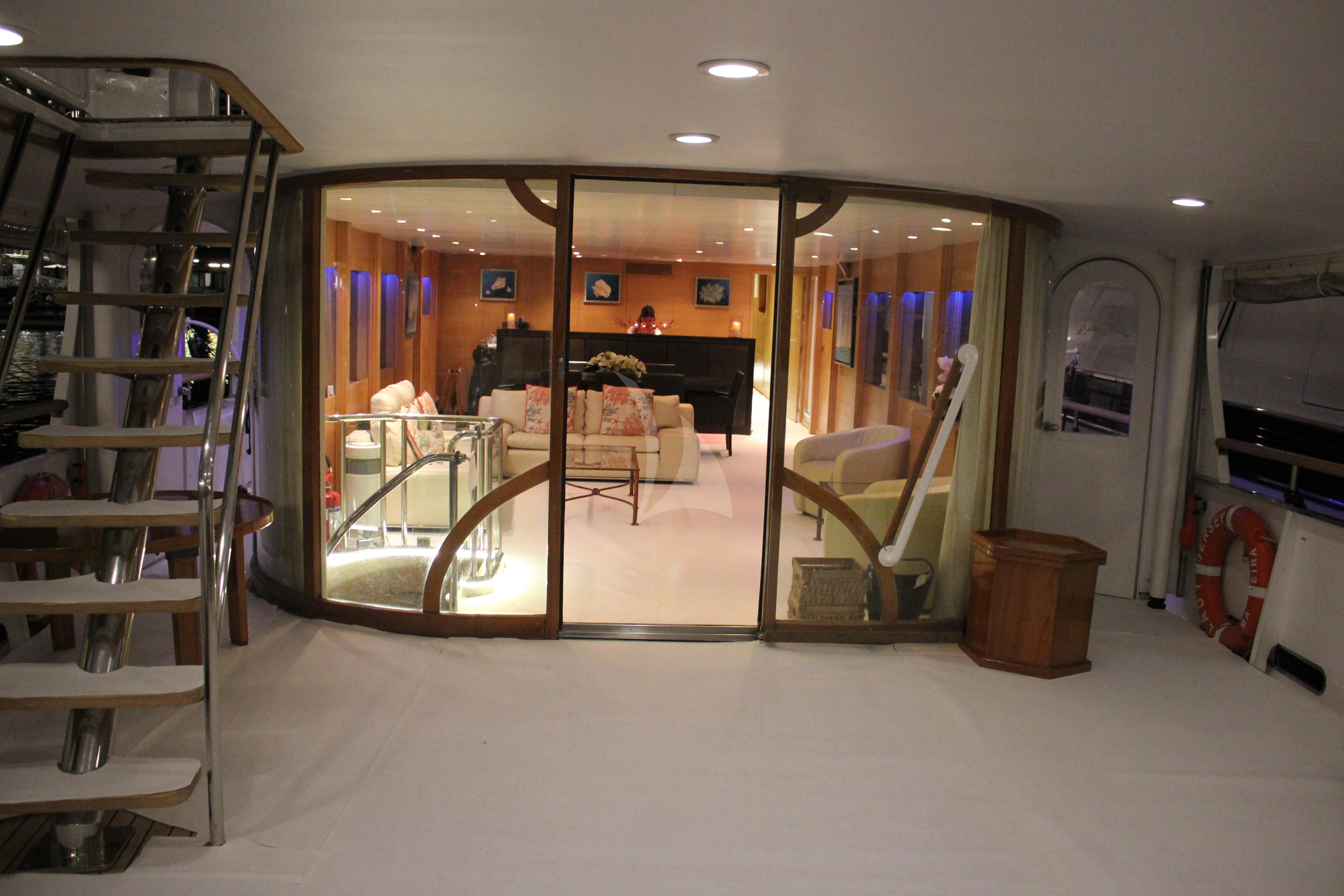 a room with a glass door and a mirror aboard LADY JERSEY Yacht for Charter