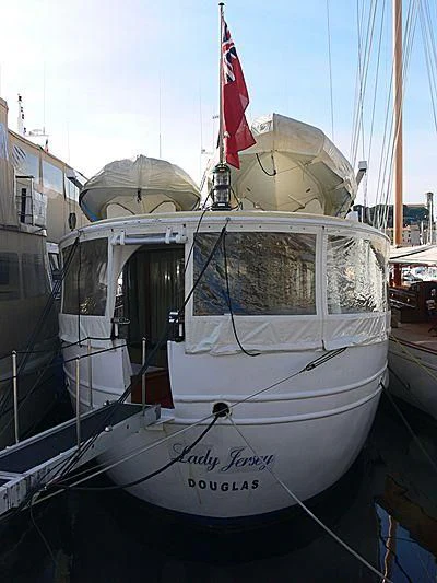 a boat with a flag on the front aboard LADY JERSEY Yacht for Charter