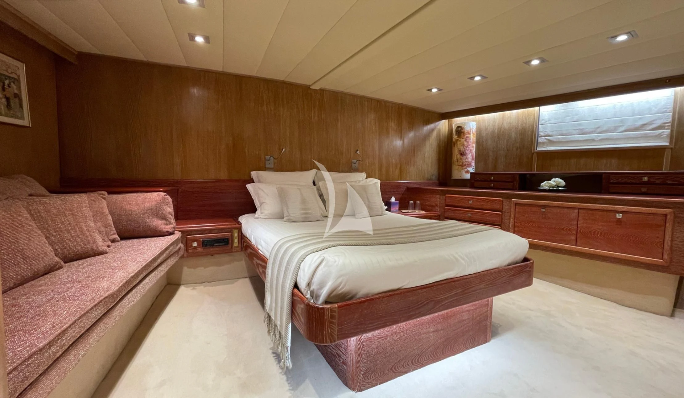 a room with a bed and a couch aboard LADY JERSEY Yacht for Charter