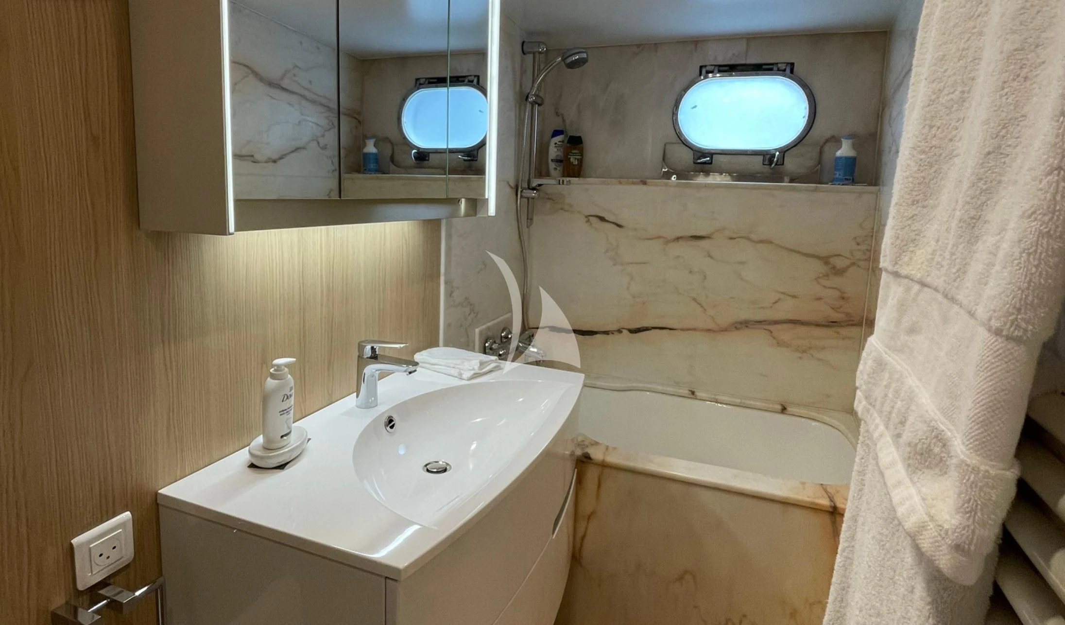 a bathroom with a sink and bathtub aboard LADY JERSEY Yacht for Charter