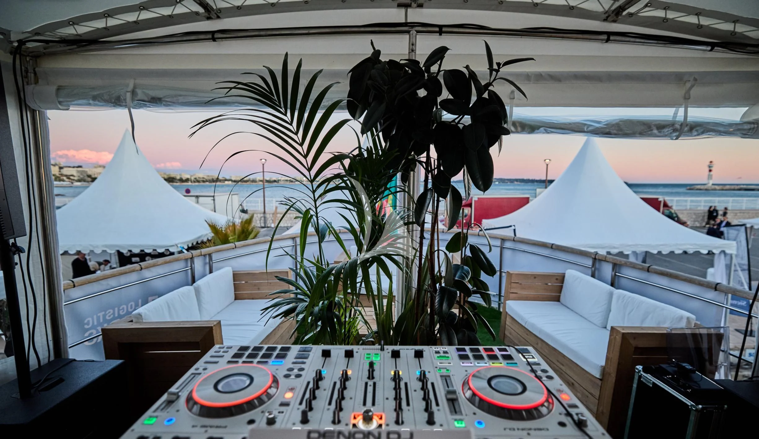 a room with a table and a sign with plants and a large sculpture aboard LADY JERSEY Yacht for Charter