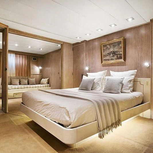 a room with a bed and a couch aboard LADY JERSEY Yacht for Charter