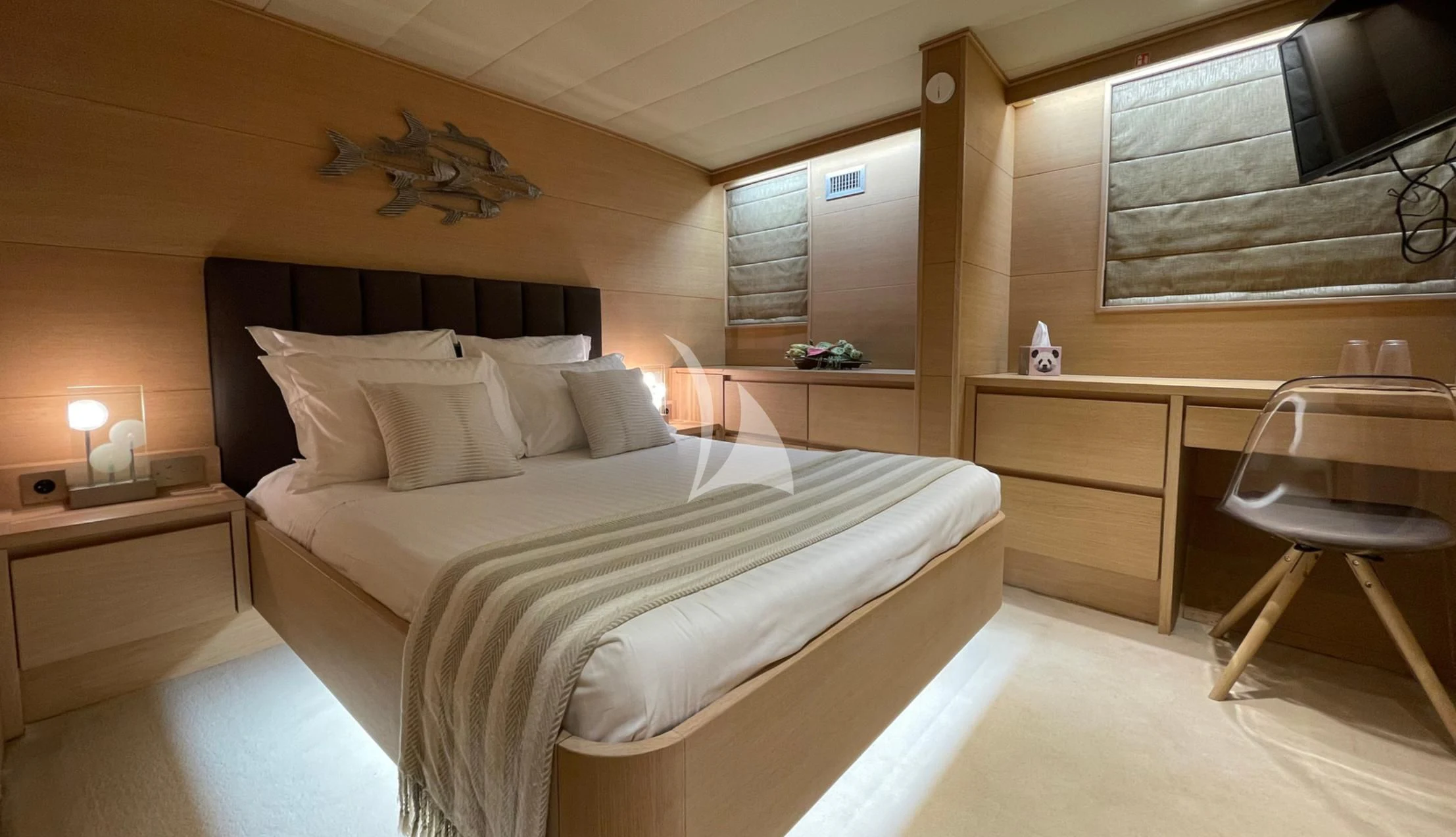 a bedroom with a bed and a desk aboard LADY JERSEY Yacht for Charter