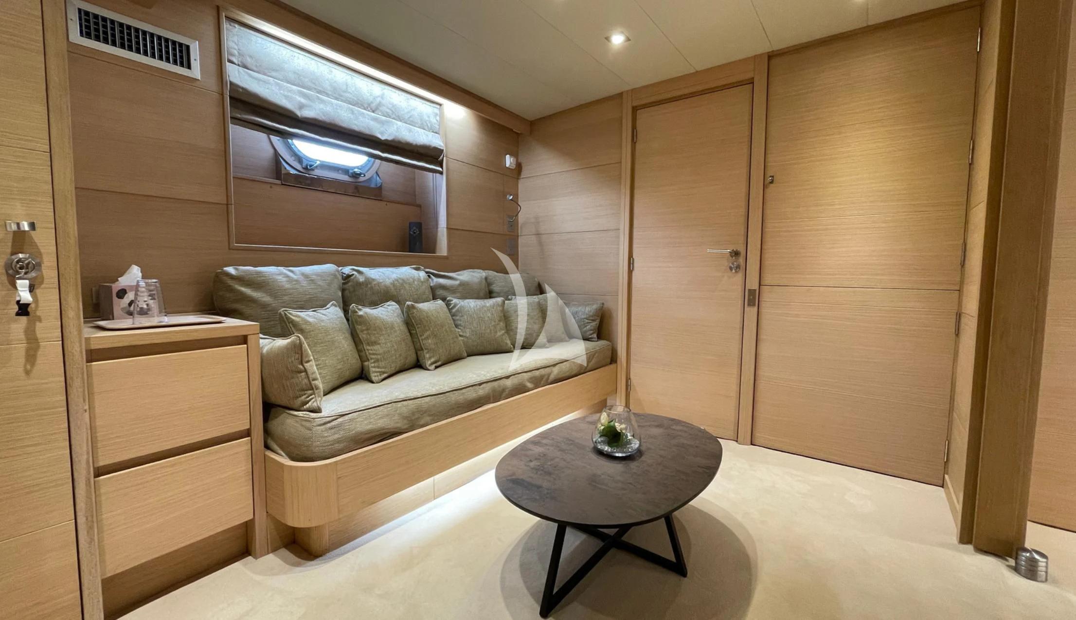 a room with a bed and a table aboard LADY JERSEY Yacht for Charter