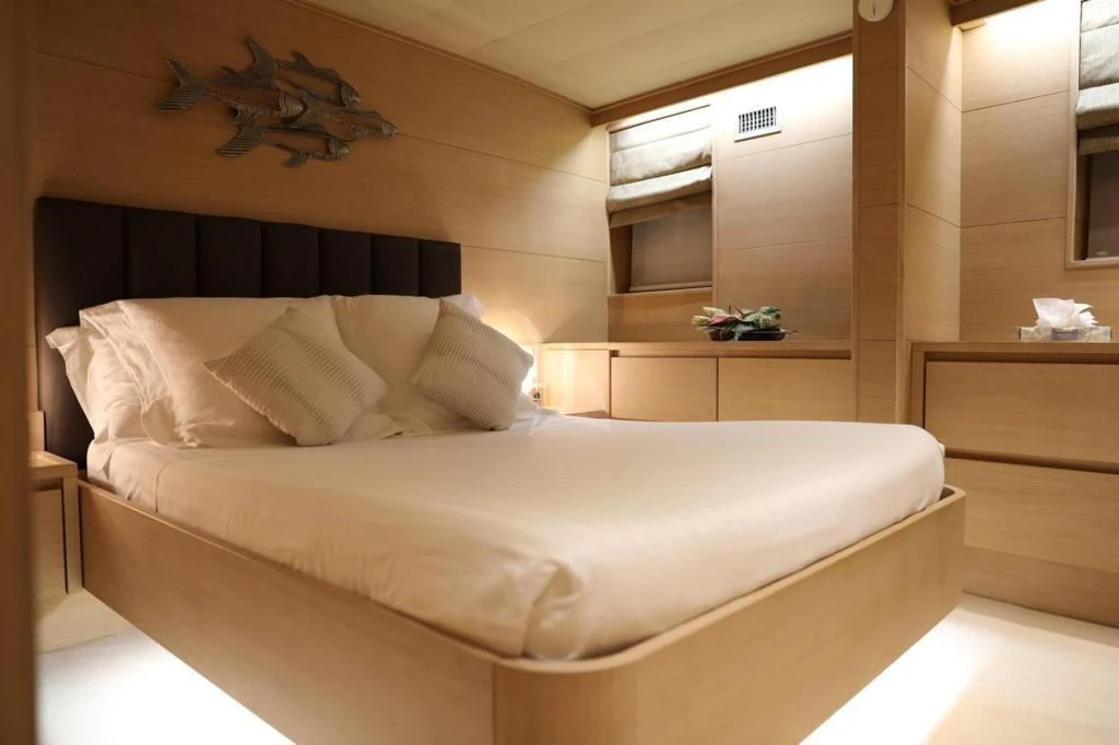 a bed with white sheets aboard LADY JERSEY Yacht for Charter