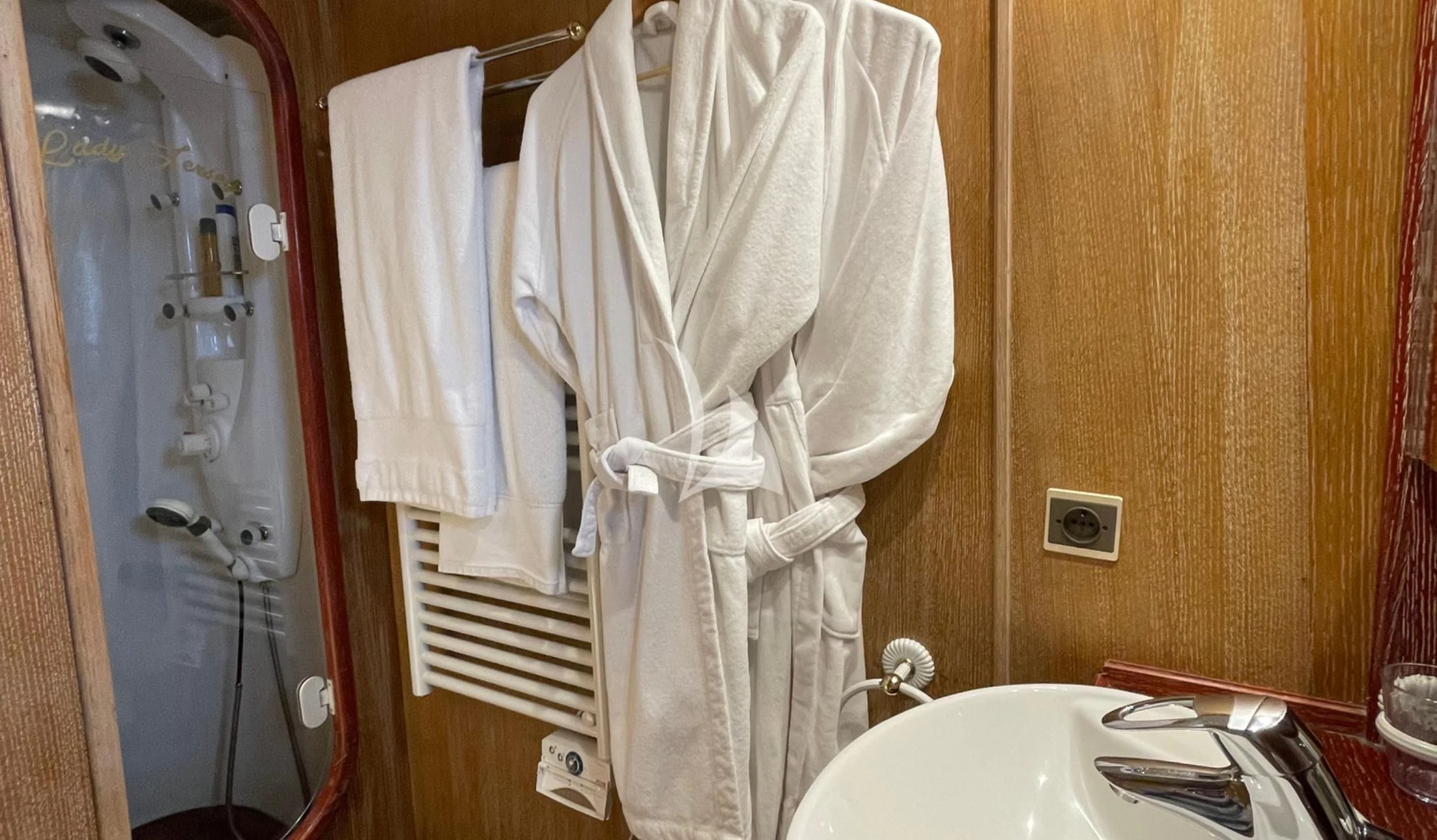 a bathroom with a robe on the wall aboard LADY JERSEY Yacht for Charter