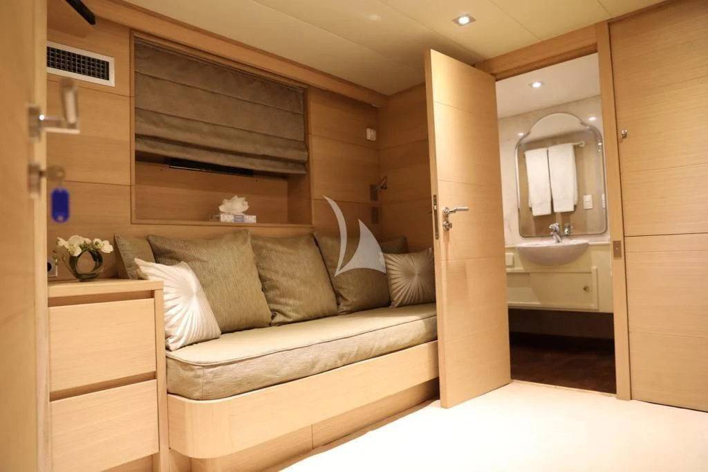 a room with a bed and a mirror aboard LADY JERSEY Yacht for Charter