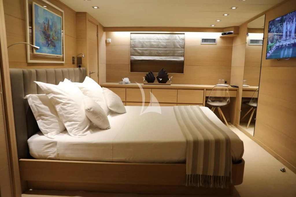a bed with white sheets aboard LADY JERSEY Yacht for Charter