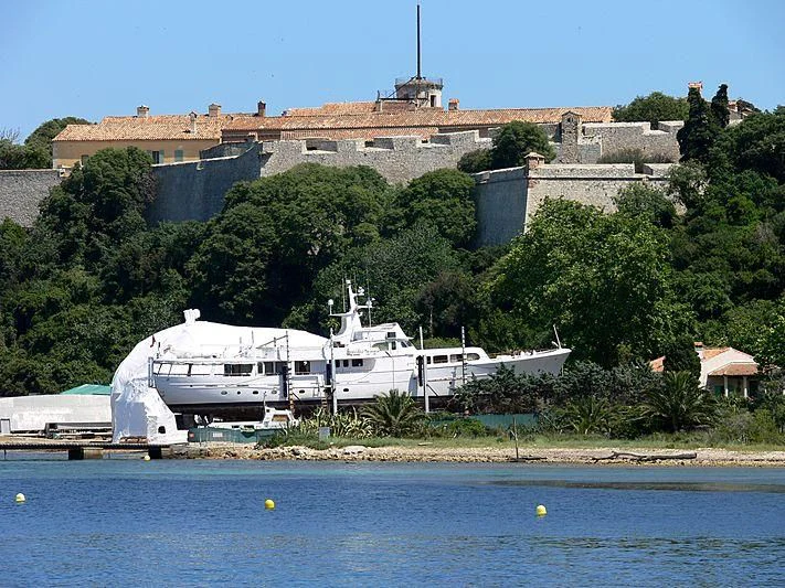 a large white boat in front of a building aboard LADY JERSEY Yacht for Charter