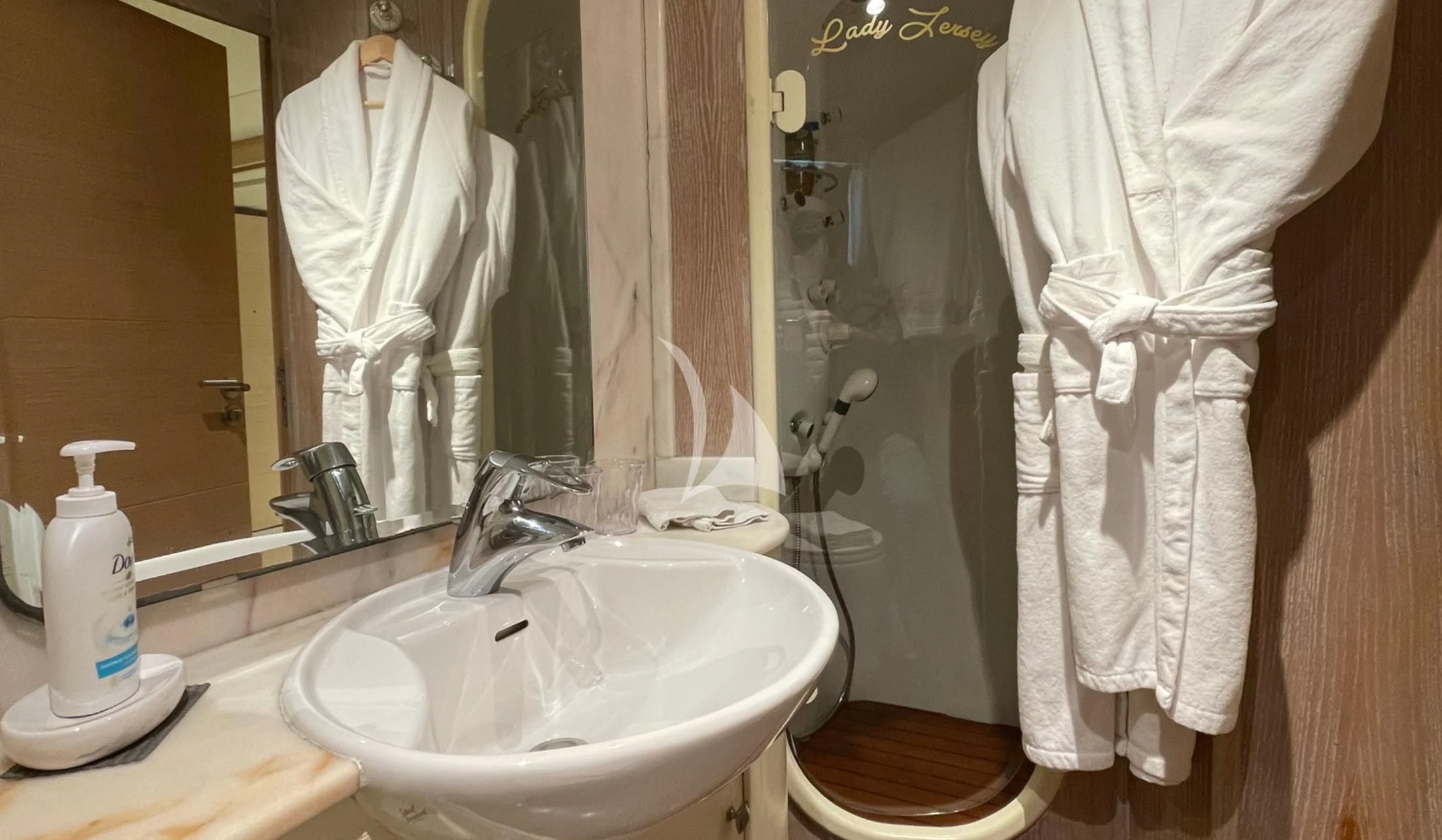 a bathroom with a robe and a sink aboard LADY JERSEY Yacht for Charter
