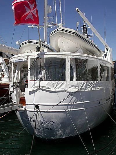 a boat with a flag on the front aboard LADY JERSEY Yacht for Charter