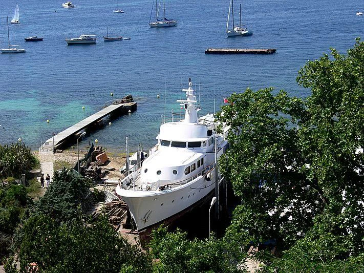 a boat is parked on the side of a river aboard LADY JERSEY Yacht for Charter